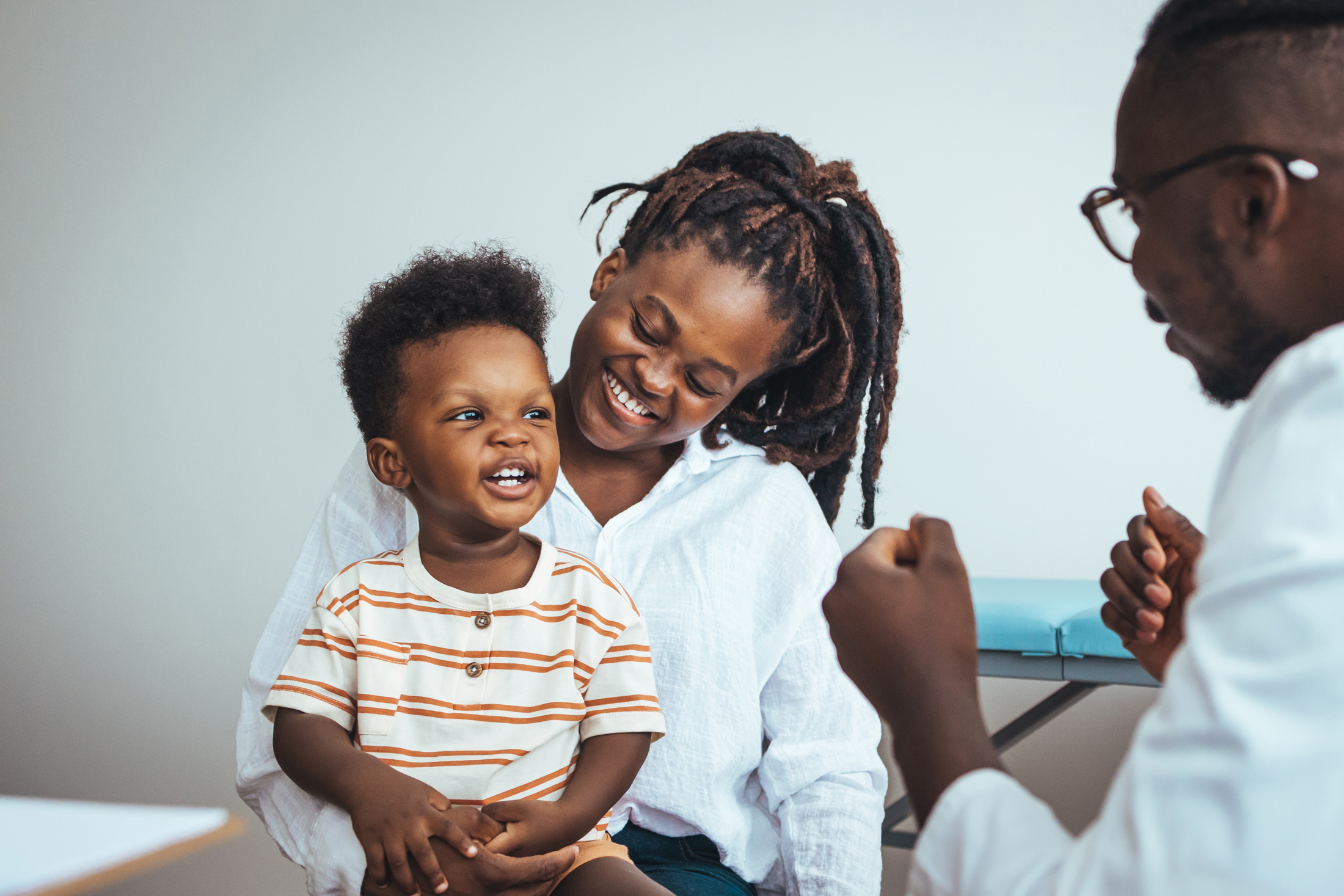 Woman with child on her lap that a doctor is talking to